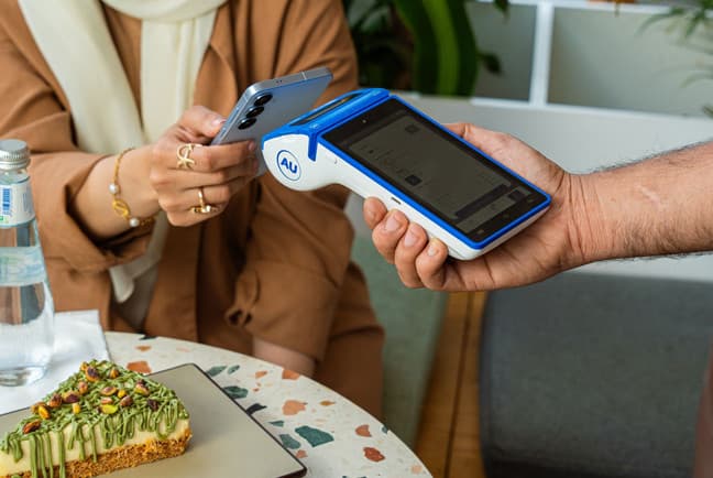 Alhamrani Universal payment terminal in use at a café table
